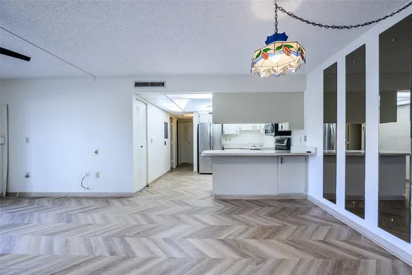 a view of kitchen with refrigerator and microwave