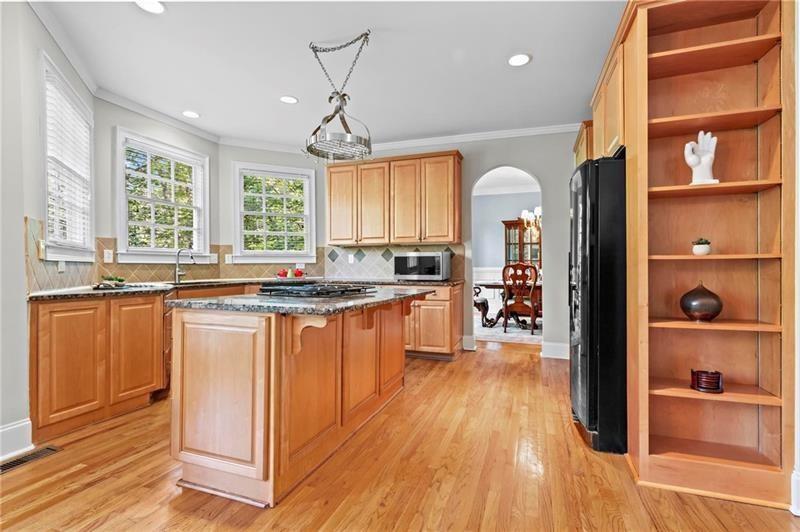 1169 Dawn View Lane Northwest Atlanta, GA 30327 - Photo 12 of 61 a kitchen with stainless steel appliances granite countertop a refrigerator a sink dishwasher a stove and white countertops with wooden floor