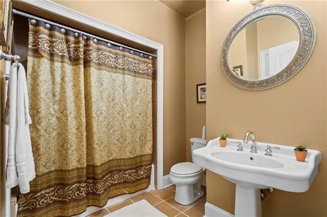 a bathroom with a sink a toilet and a mirror