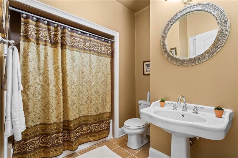 1169 Dawn View Lane Northwest Atlanta, GA 30327 - Photo 21 of 61 a bathroom with a sink a toilet and a mirror