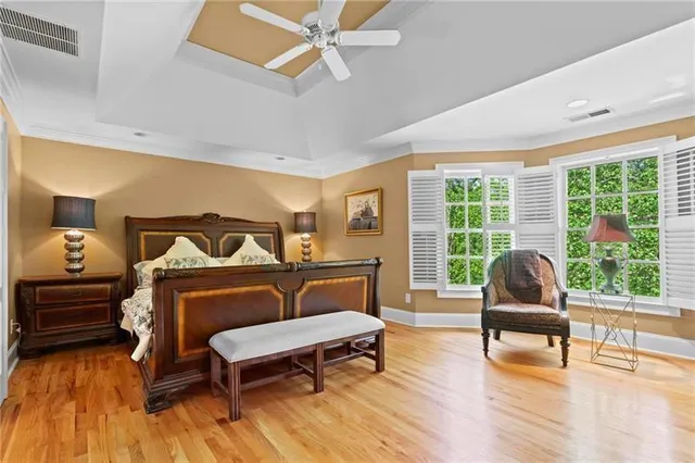 a bedroom with furniture and wooden floor