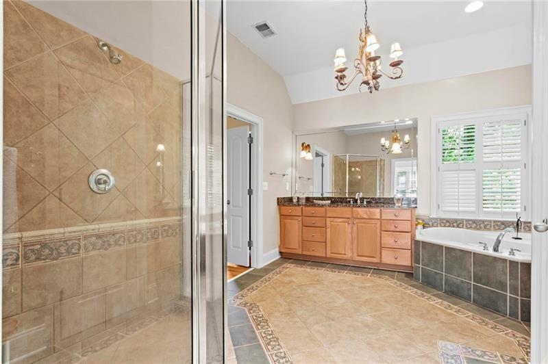 1169 Dawn View Lane Northwest Atlanta, GA 30327 - Photo 25 of 61 a large bathroom with a tub shower and sink