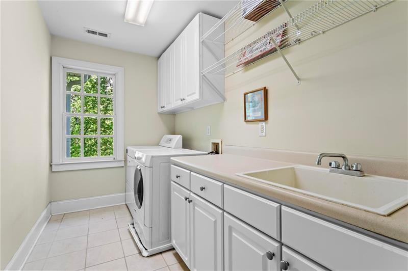 1169 Dawn View Lane Northwest Atlanta, GA 30327 - Photo 33 of 61 a utility room with a sink dryer and washer