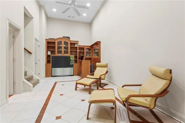 a living room with furniture a window and gym equipment