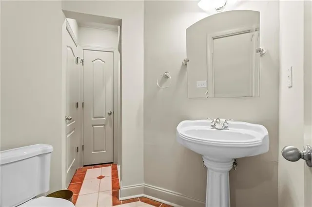 a bedroom with a bed and large windows