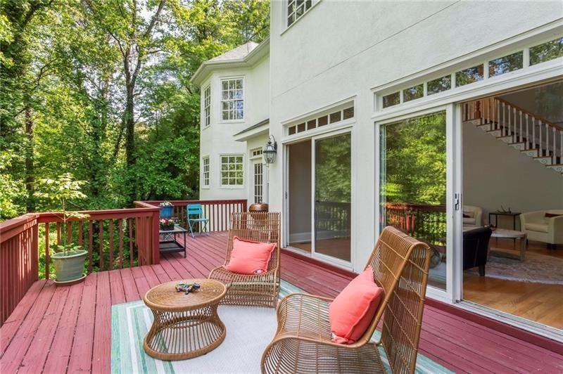 1169 Dawn View Lane Northwest Atlanta, GA 30327 - Photo 46 of 61 a view of a patio with couches chairs potted plants and wooden floor