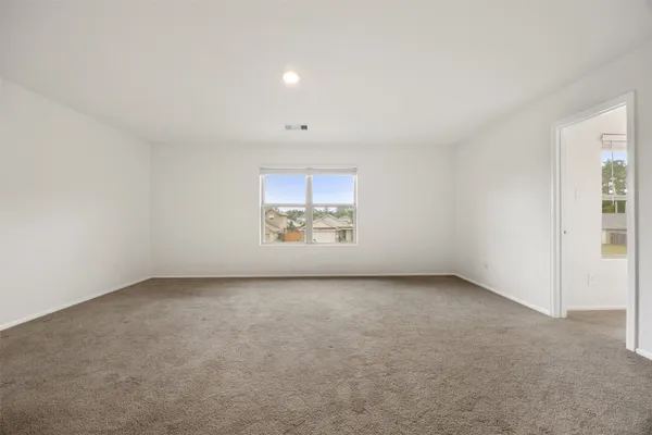 an empty room with a empty space and windows