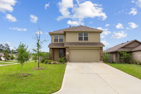 a view of empty room with wooden floor and windows