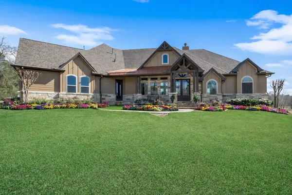 a front view of house with yard and green space
