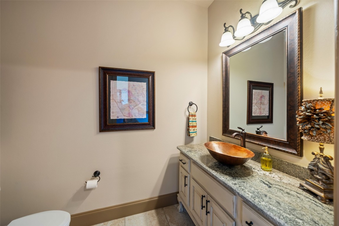 40 Stewart Road New Waverly, TX 77358 - Photo 18 of 50 a bathroom with a granite countertop sink and a mirror with toilet