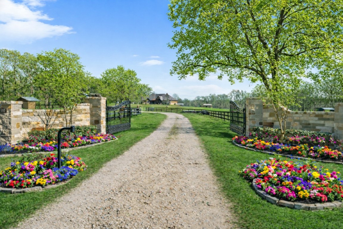 40 Stewart Road New Waverly, TX 77358 - Photo 2 of 50 a view of a garden with flowers and trees