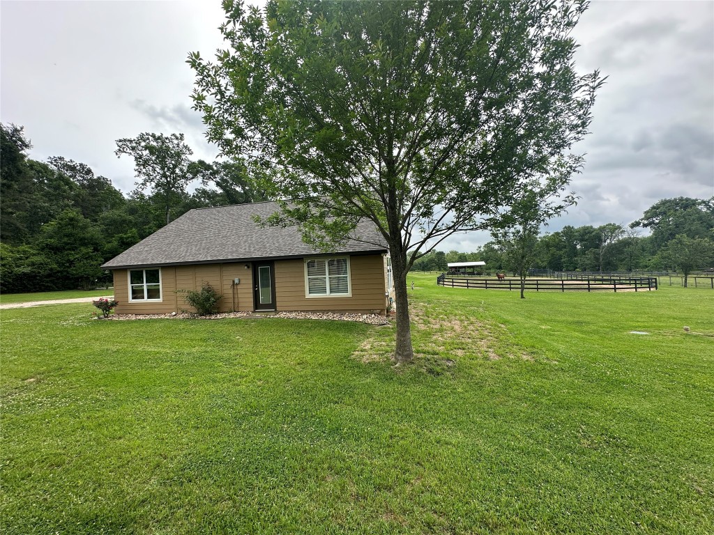 40 Stewart Road New Waverly, TX 77358 - Photo 28 of 50 a house that is sitting in the grass with large trees