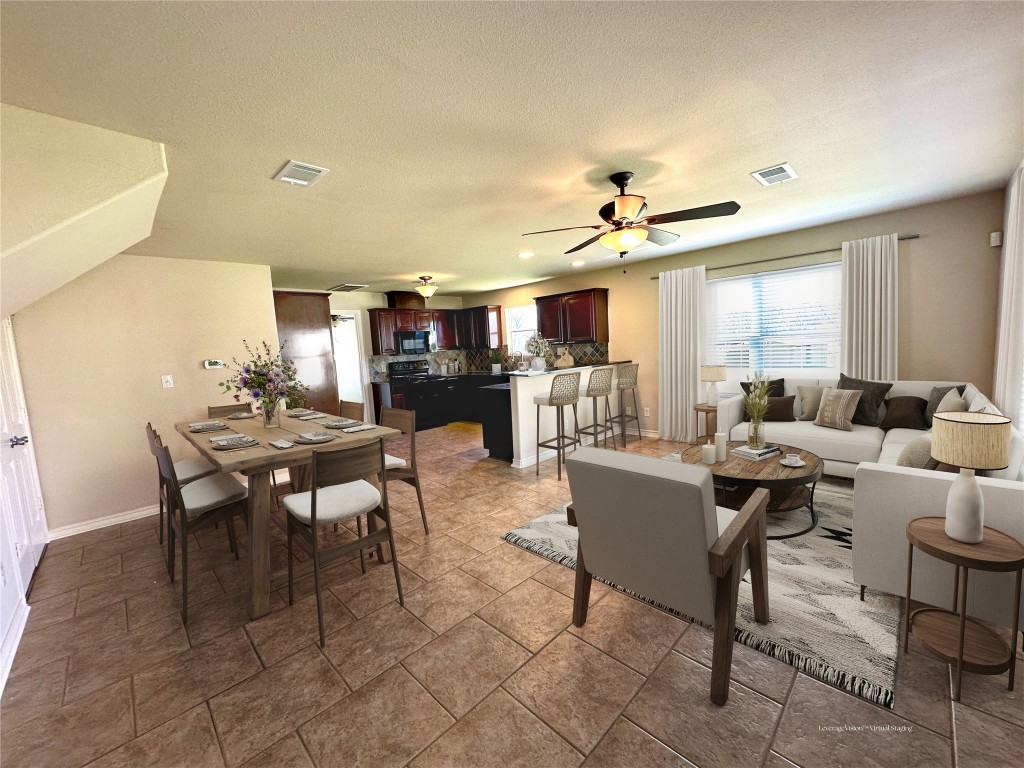 40 Stewart Road New Waverly, TX 77358 - Photo 31 of 50 a living room with furniture a chandelier and a dining table with a kitchen view