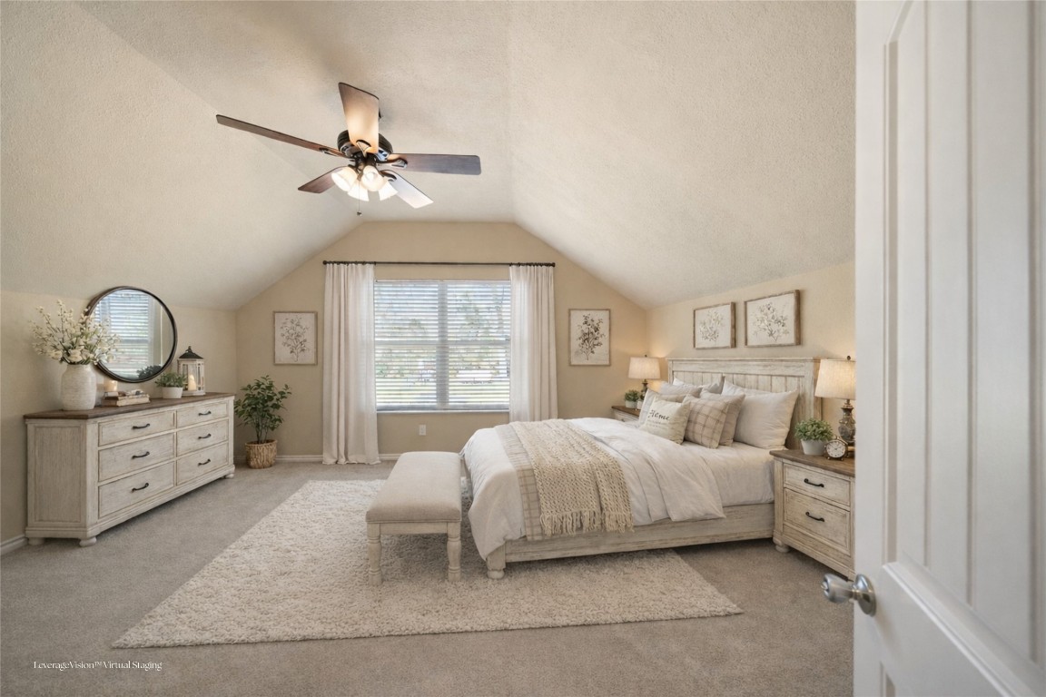 40 Stewart Road New Waverly, TX 77358 - Photo 37 of 50 a spacious bedroom with a bed a chandelier and large window