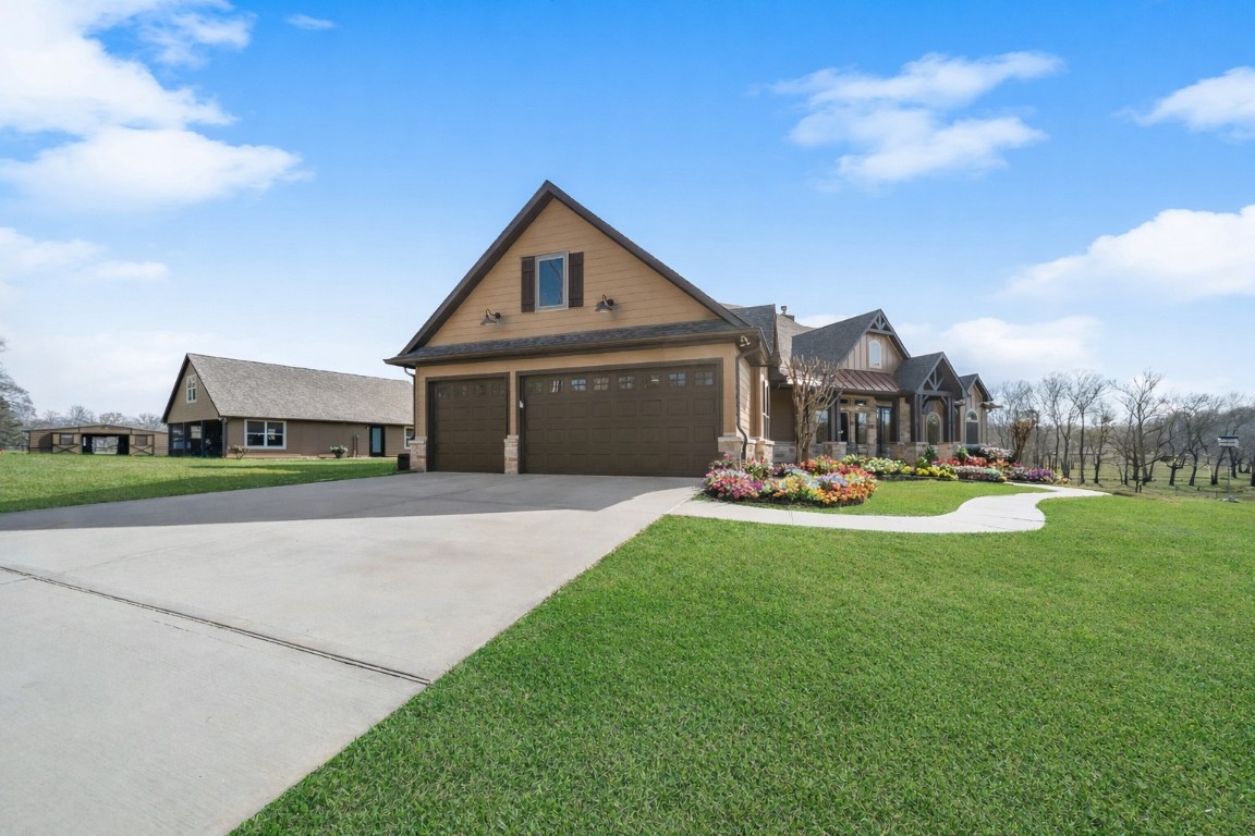 40 Stewart Road New Waverly, TX 77358 - Photo 4 of 50 a front view of a house with garden