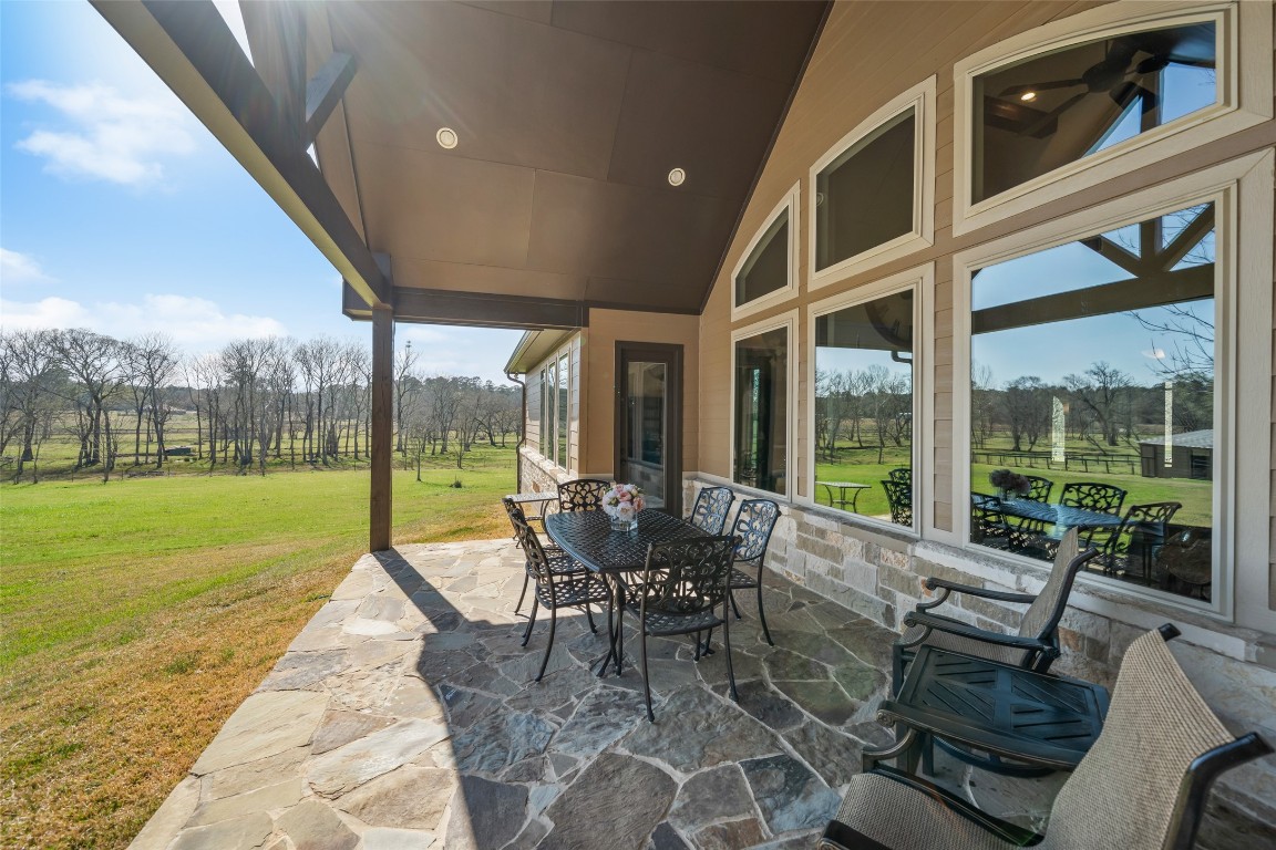 40 Stewart Road New Waverly, TX 77358 - Photo 42 of 50 a patio with yard glass top table and chairs