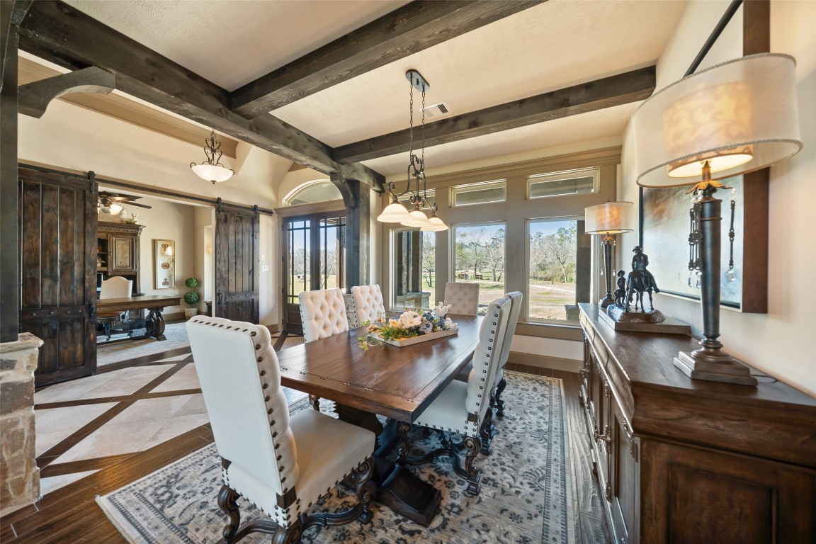 40 Stewart Road New Waverly, TX 77358 - Photo 6 of 50 a dining room with furniture a chandelier and wooden floor
