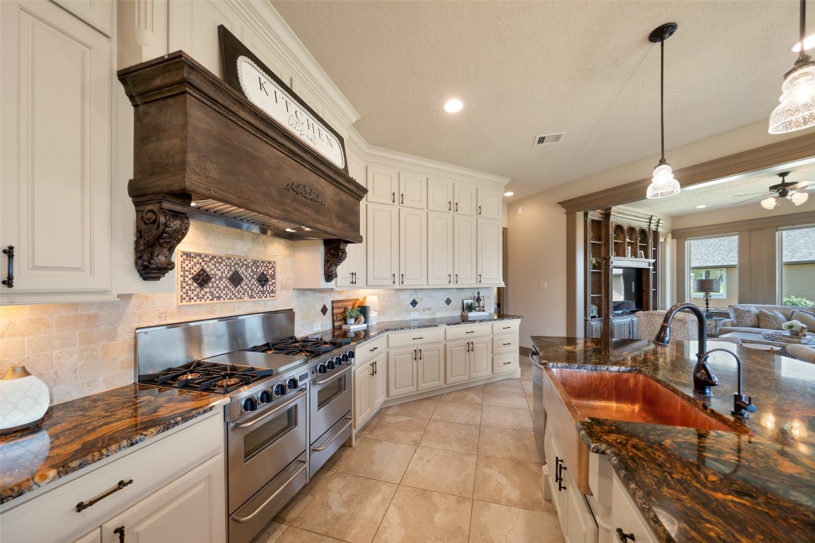 40 Stewart Road New Waverly, TX 77358 - Photo 9 of 50 a kitchen with stainless steel appliances granite countertop a stove a sink dishwasher and cabinets with wooden floor