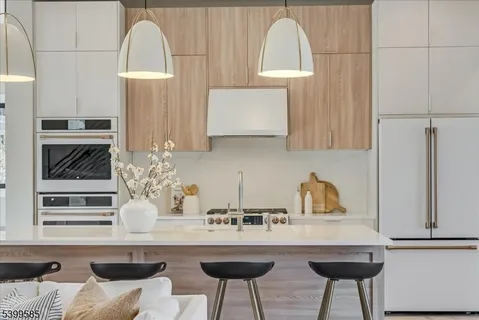 a kitchen with stainless steel appliances a sink and cabinets