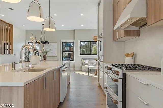 a kitchen with stainless steel appliances a sink stove and cabinets