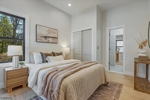 a bedroom with bed and a night stand