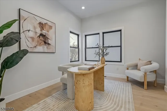 a living room with a couch and paintings on the wall