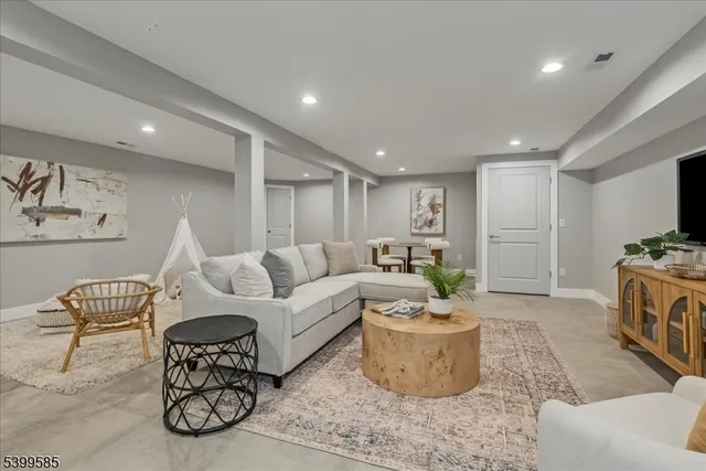 a living room with furniture a rug and a fireplace