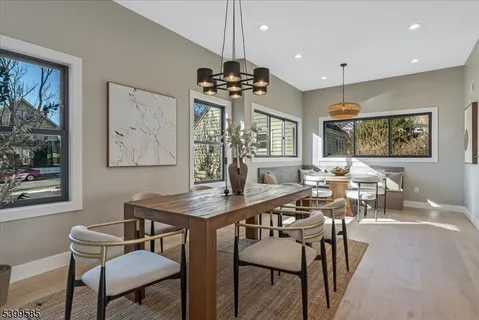 a view of a a dining room with furniture window and wooden floor