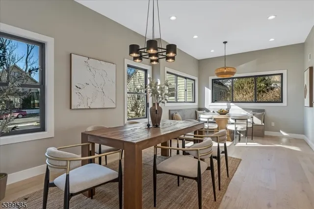 a view of a a dining room with furniture window and wooden floor