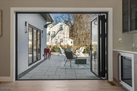 a living room with a large window and furniture