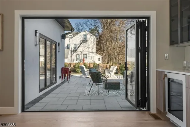 a living room with a large window and furniture