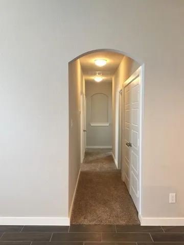 a view of a hallway with wooden shelves