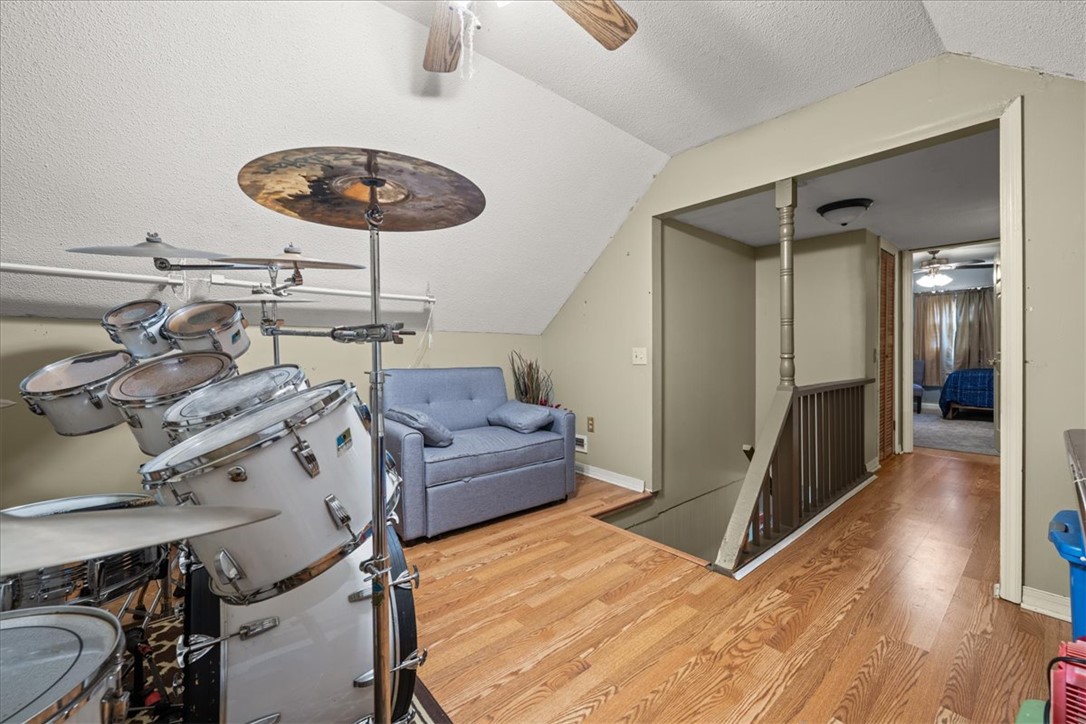 668 Marcengill Road Westminster, SC 29693 - Photo 29 of 37 A versatile loft space featuring warm hardwood flooring and a functional sloped ceiling.