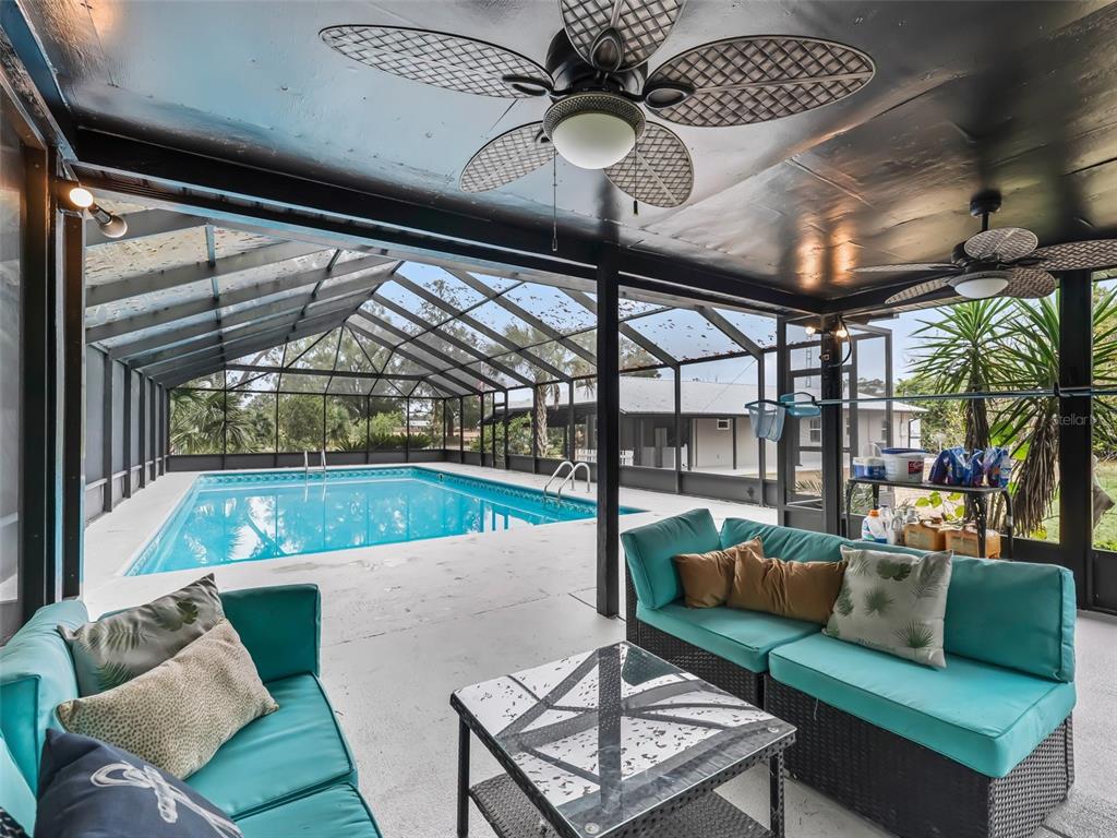 3505 Northeast 97th Street Road Anthony, FL 32617 - Photo 28 of 38 a living room with patio furniture and a floor to ceiling window