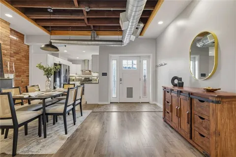 a view of a dining room with furniture and a chandelier