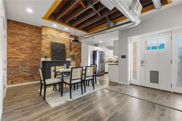 a dining room with furniture and wooden floor