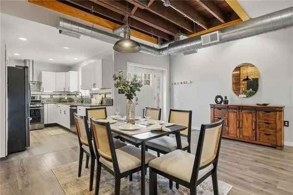 a view of a dining room with furniture and wooden floor