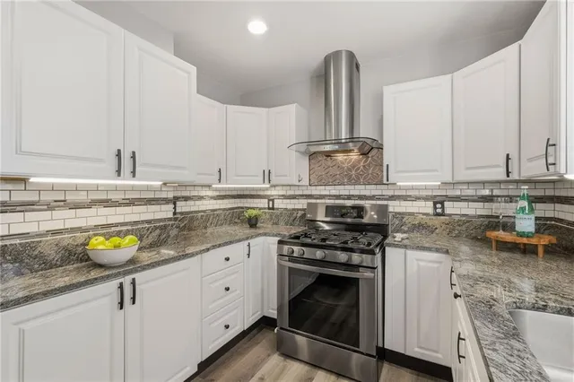 a kitchen with a sink a stove and cabinets