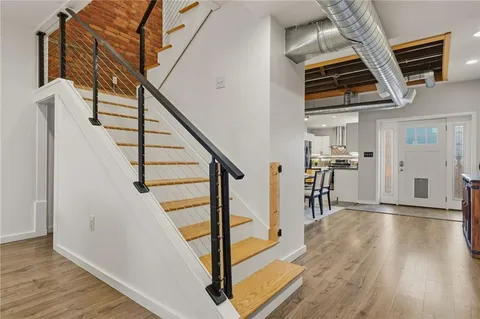 a view of an entryway with wooden floor and stairs