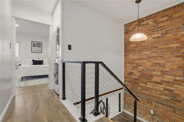 a view of a livingroom with wooden floor and staircase