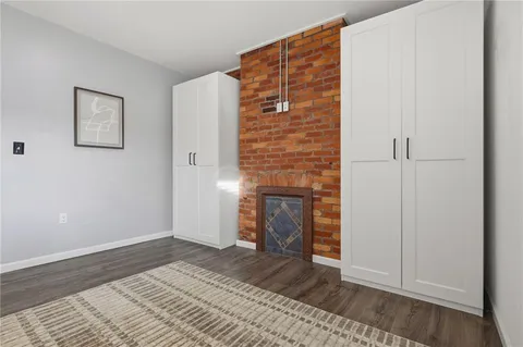 a view of empty room with a fireplace