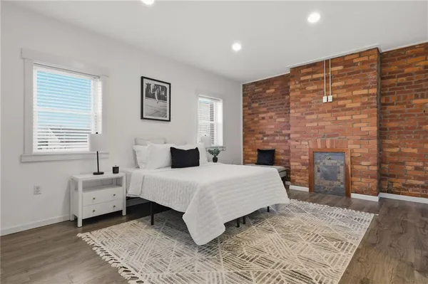 a spacious bedroom with a bed and a fireplace