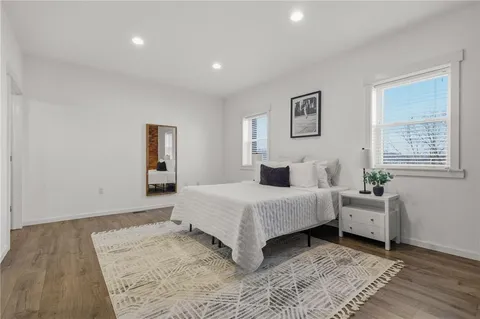 a spacious bedroom with a bed and a window