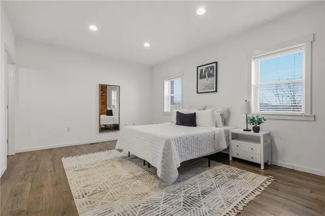 a spacious bedroom with a bed and a window