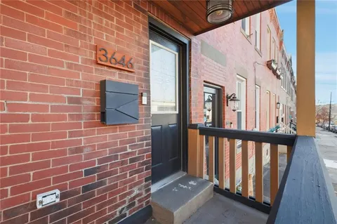 a view of a brick house with a large window