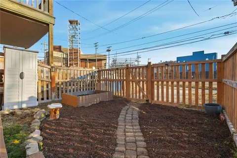 a view of a house with wooden fence