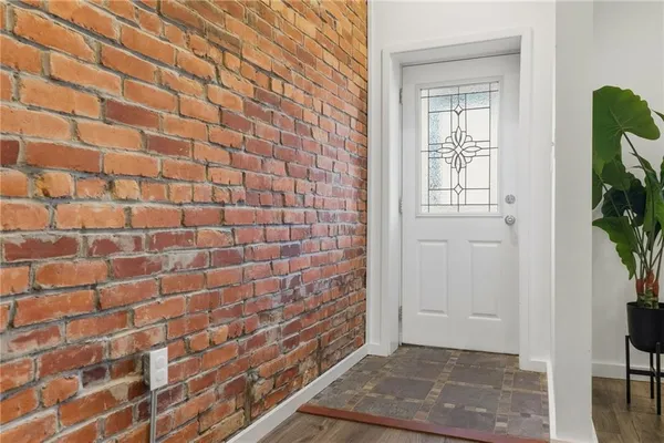 a view of an empty room and wooden floor