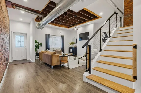 a living room with wooden floor and furniture