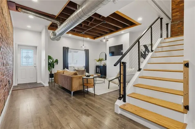 a living room with wooden floor and furniture