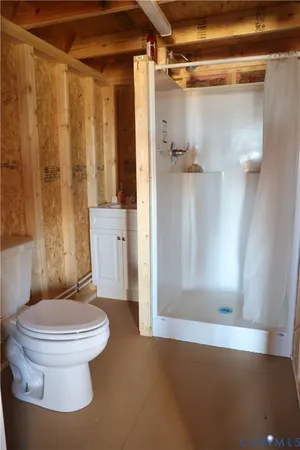 a bathroom with a toilet and a shower